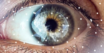 Closeup of a human eye, with geometric shapes mapping random patterns