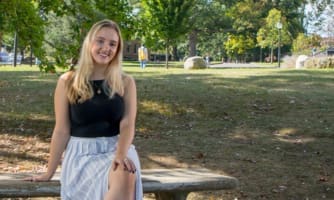 Brianna Parker sitting on park bench.