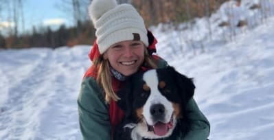 Headshot of Heather Quintal hugging her saint bernard