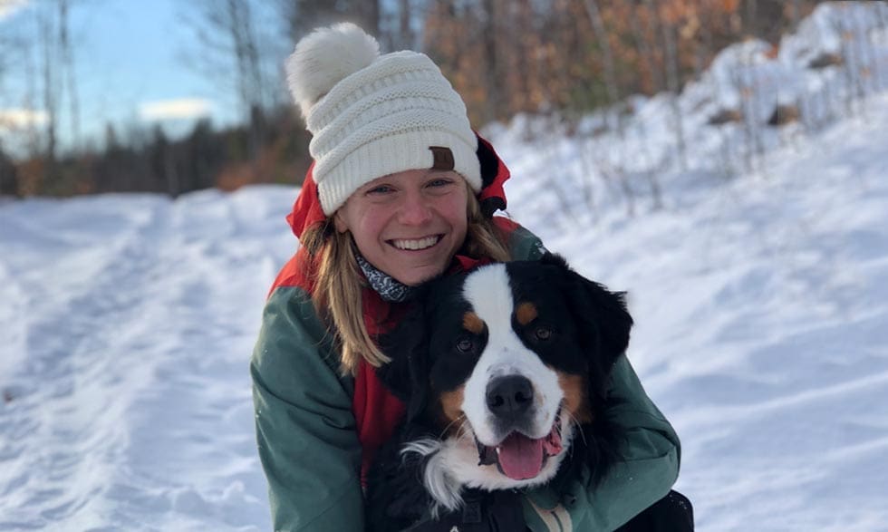Headshot of Heather Quintal hugging her saint bernard